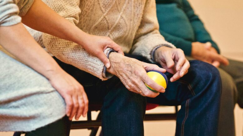 elderly holding a ball