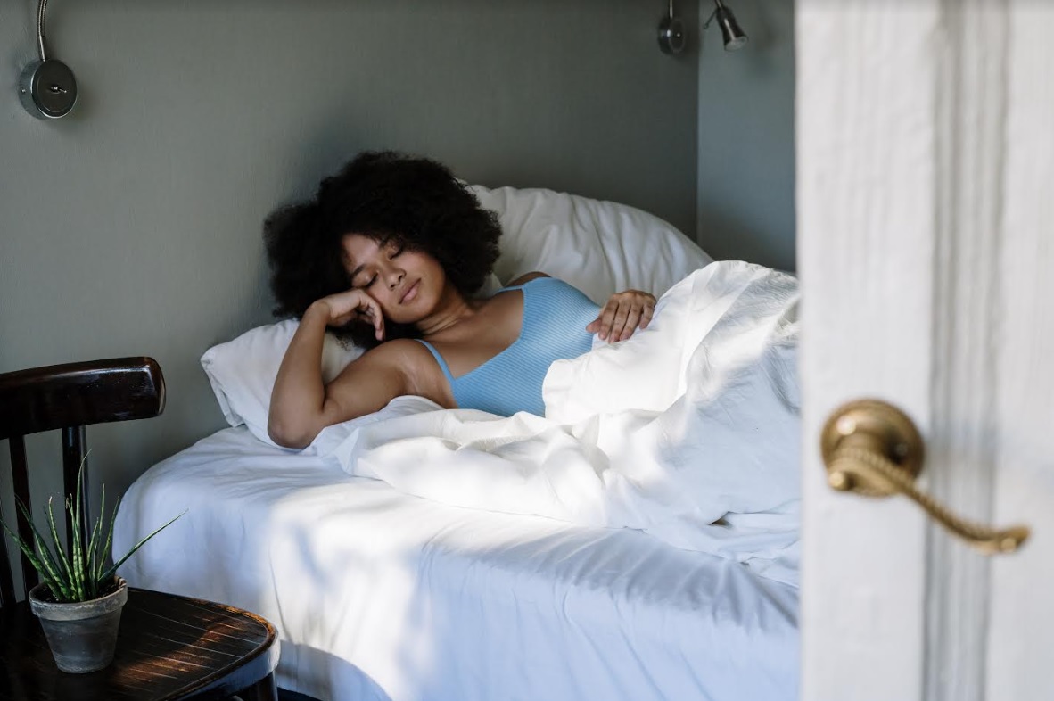 black woman sleeping on bed