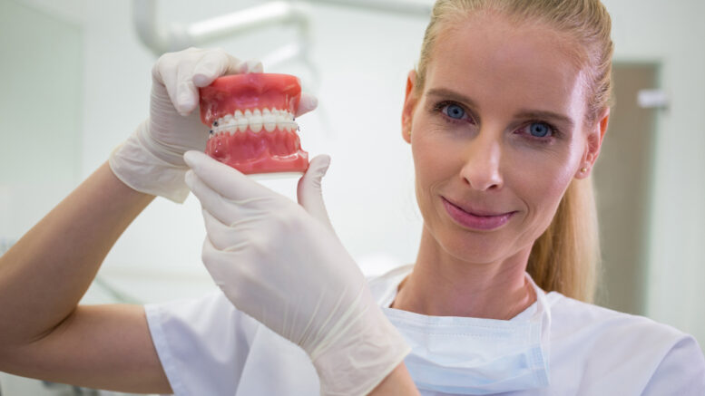 female-dentist-with-dentures