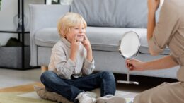 child looking at mirror