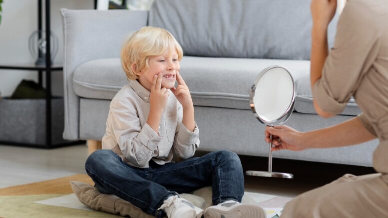 child looking at mirror